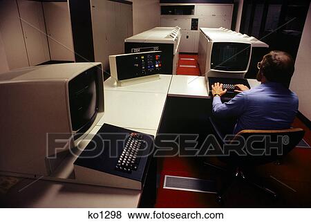 1970s 1980s man seated at computer workstation View Large Photo Image Stock Photo - 1970s 1980s man seated at computer workstation. Fotosearch