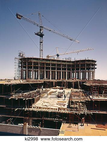 1970s 1980s office building construction site with two cranes View Large Photo Image Stock Photo - 1970s 1980s office building construction site with two cranes. Fotosearch