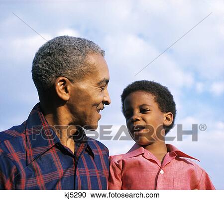 Stock Image - 1970s african-american grandfather and boy. Fotosearch