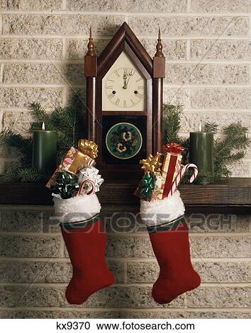 1970s antique clock fireplace mantle christmas stockings full presents candy canes View Large Photo Image Stock Image - 1970s antique clock fireplace mantle christmas stockings full presents candy canes. Fotosearch