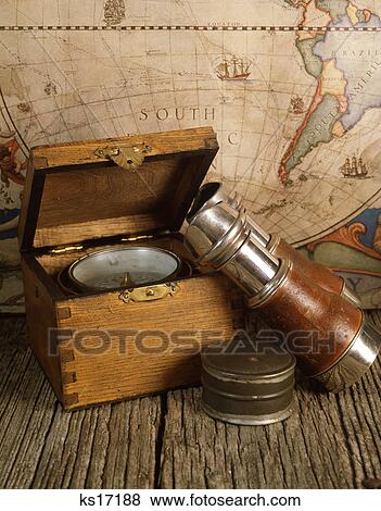 Stock Photo - 1970s antique world map binoculars compass nautical still life. Fotosearch