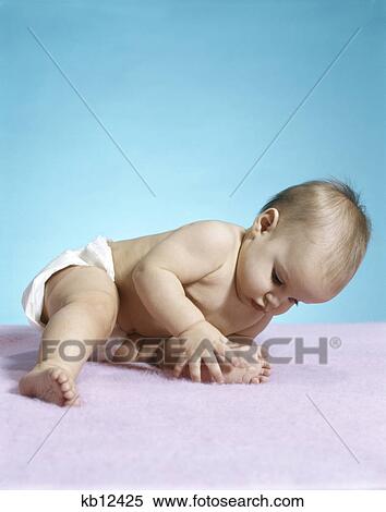 1970s baby wearing diaper leaning over holding foot View Large Photo Image Stock Photography - 1970s baby wearing diaper leaning over holding foot. Fotosearch