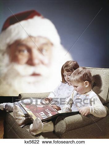 1970s boy girl sitting in chair reading a book together as background santa face watches View Large Photo Image Stock Image - 1970s boy girl sitting in chair reading a book together as background santa face watches. Fotosearch