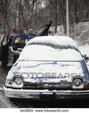1970s car covered with light snow being towed by tow truck View Large Photo Image Stock Photography - 1970s car covered with light snow being towed by tow truck. Fotosearch
