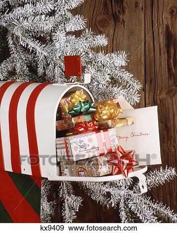 Stock Photo - 1970s christmas mailbox full of presents and cards. Fotosearch