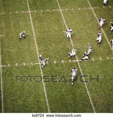 1970s college football game player kicking football action sports View Large Photo Image Picture - 1970s college football game player kicking football action sports. Fotosearch