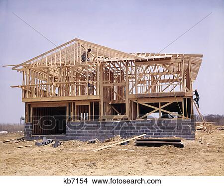 Picture - 1970s concrete cinder block and wood frame house under construction. Fotosearch