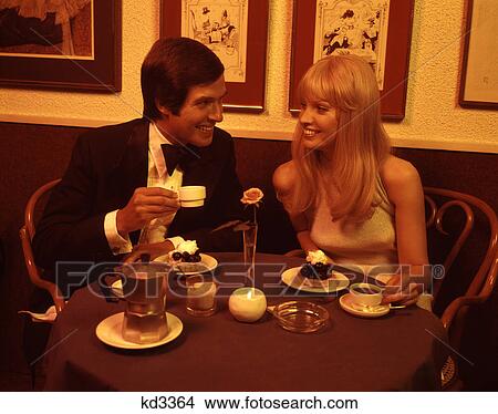 1970s couple dining romantic restaurant having dessert coffee by candlelight View Large Photo Image Picture - 1970s couple dining romantic restaurant having dessert coffee by candlelight. Fotosearch