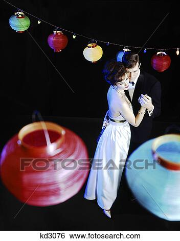 1970s couple in formal clothes dancing under colored paper chinese lanterns View Large Photo Image Stock Photograph - 1970s couple in formal clothes dancing under colored paper chinese lanterns. Fotosearch