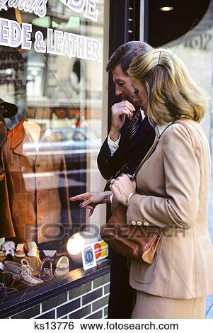1970s couple man woman window shopping View Large Photo Image Stock Photograph - 1970s couple man woman window shopping. Fotosearch