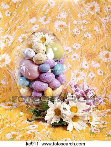 1970s easter still life malted candy eggs inside egg shaped container daisies yellow background View Large Photo Image Stock Image - 1970s easter still life malted candy eggs inside egg shaped container daisies yellow background. Fotosearch