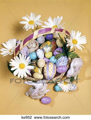 1970s easter still life overhead view basket filled with candy decorated eggs daisies bunny figurines View Large Photo Image Stock Image - 1970s easter still life overhead view basket filled with candy decorated eggs daisies bunny figurines. Fotosearch