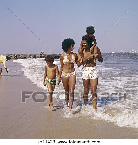 Stock Image - 1970s family african american beach. Fotosearch