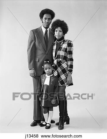 Stock Photo - 1970s family man woman girl standing together. Fotosearch