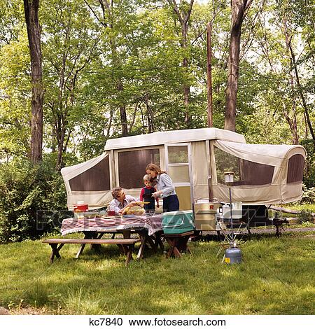 1970s family mother father son camping having picnic by camper summer vacation View Large Photo Image Stock Image - 1970s family mother father son camping having picnic by camper summer vacation. Fotosearch