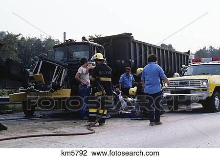 1970s firemen and emergency services on scene of truck traffic accident View Large Photo Image Stock Image - 1970s firemen and emergency services on scene of truck traffic accident. Fotosearch