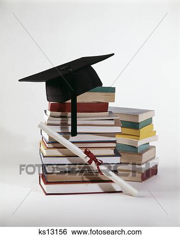 1970s graduation still life of diploma and mortarboard on top of pile stack of books View Large Photo Image Stock Photograph - 1970s graduation still life of diploma and mortarboard on top of pile stack of books. Fotosearch