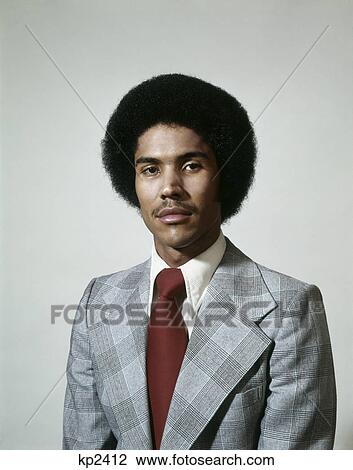 1970s head shoulder portrait of serious african american man with afro hairdo wearing gray plaid suit and red tie View Large Photo Image Stock Image - 1970s head shoulder portrait of serious african american man with afro hairdo wearing gray plaid suit and red tie. Fotosearch
