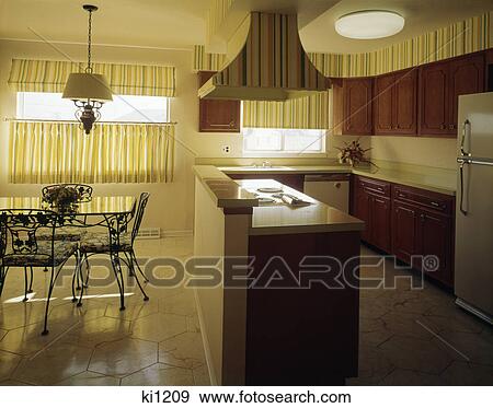 1970s kitchen and dining area with yellow striped curtains wallpaper and dark wooden cabinets View Large Photo Image Stock Photo - 1970s kitchen and dining area with yellow striped curtains wallpaper and dark wooden cabinets. Fotosearch