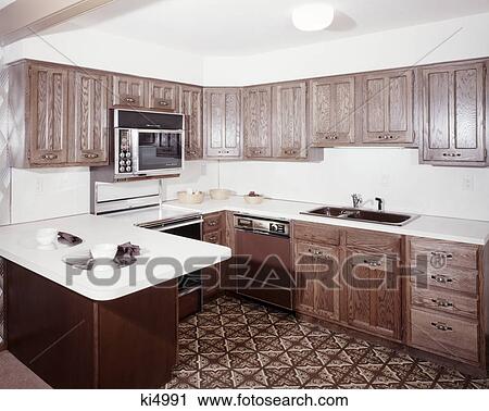 1970s kitchen with dark wooden cabinets and a microwave oven over the stove View Large Photo Image Stock Image - 1970s kitchen with dark wooden cabinets and a microwave oven over the stove. Fotosearch