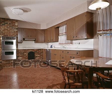 1970s kitchen with dark wooden cabinets brick wall and double oven View Large Photo Image Stock Photo - 1970s kitchen with dark wooden cabinets brick wall and double oven. Fotosearch