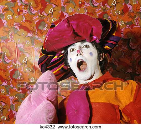 1970s man circus clown wearing colorful floppy hat pink orange costume open mouth surprised expression View Large Photo Image Stock Image - 1970s man circus clown wearing colorful floppy hat pink orange costume open mouth surprised expression. Fotosearch