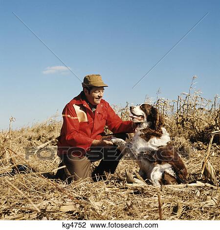1970s man hunter in field with his dog View Large Photo Image Stock Image - 1970s man hunter in field with his dog. Fotosearch