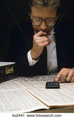 1970s man studying financial pages of newspaper View Large Photo Image Stock Image - 1970s man studying financial pages of newspaper. Fotosearch