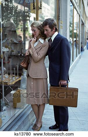 1970s man woman couple suit briefcase window shopping View Large Photo Image Stock Image - 1970s man woman couple suit briefcase window shopping. Fotosearch
