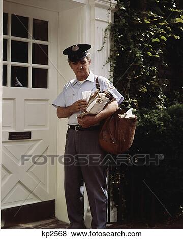 1970s middle aged mailman standing by white door sorting mail for delivery View Large Photo Image Stock Photo - 1970s middle aged mailman standing by white door sorting mail for delivery. Fotosearch