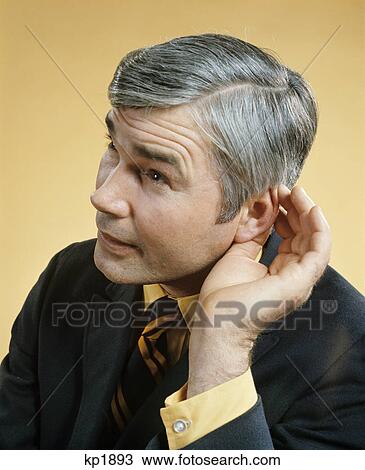 1970s middle aged man cupping ear with hand listening hearing View Large Photo Image Stock Image - 1970s middle aged man cupping ear with hand listening hearing. Fotosearch