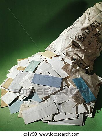 Stock Image - 1970s open bag of mail with letters spilling out. Fotosearch