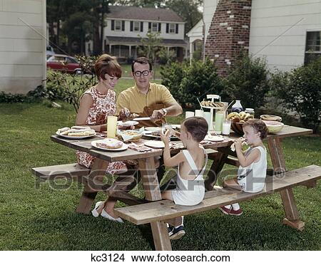 Picture - 1970s picnic table family back yard. Fotosearch