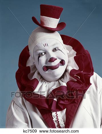 Stock Photo - 1970s portrait of circus clown in red and white costume. Fotosearch