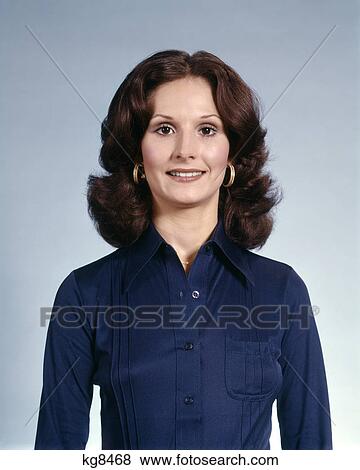 1970s portrait of smiling brunette woman wearing gold hoop earrings and blue shirt View Large Photo Image Stock Photo - 1970s portrait of smiling brunette woman wearing gold hoop earrings and blue shirt. Fotosearch