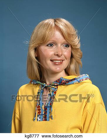 1970s portrait smiling blond woman wearing yellow hooded top with patterned trim View Large Photo Image Stock Photo - 1970s portrait smiling blond woman wearing yellow hooded top with patterned trim. Fotosearch