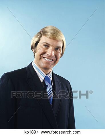 1970s portrait smiling businessman in suit and tie with blond hair in comb over style View Large Photo Image Stock Photo - 1970s portrait smiling businessman in suit and tie with blond hair in comb over style. Fotosearch