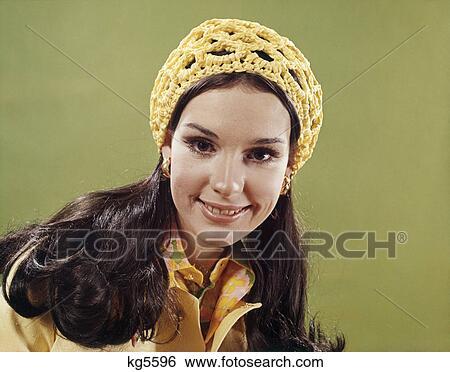 1970s portrait smiling young long hair brunette woman wearing yellow crochet cap View Large Photo Image Stock Photograph - 1970s portrait smiling young long hair brunette woman wearing yellow crochet cap. Fotosearch