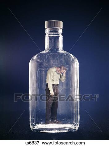 1970s sad depressed man trapped inside glass bottle alcoholism