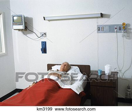 1970s senior man lying in hospital bed View Large Photo Image Stock Photo - 1970s senior man lying in hospital bed. Fotosearch