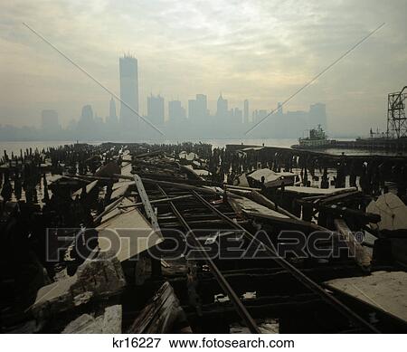1970s skyline of downtown manhattan from rotting brooklyn pier shadow of world trade center under construction View Large Photo Image Stock Photo - 1970s skyline of downtown manhattan from rotting brooklyn pier shadow of world trade center under construction. Fotosearch