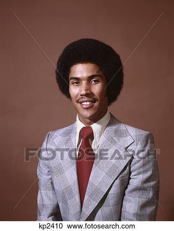 1970s smiling african-american man wearing suit tie red background View Large Photo Image Stock Image - 1970s smiling african-american man wearing suit tie red background. Fotosearch