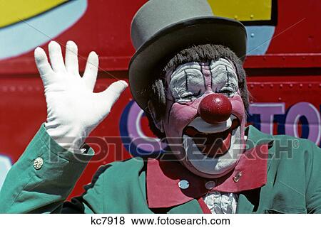 1970s smiling clown pink face green jacket waving a white gloved hand View Large Photo Image Stock Photo - 1970s smiling clown pink face green jacket waving a white gloved hand. Fotosearch