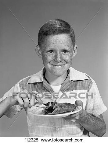1970s smiling freckle face boy eating slice of pie dessert View Large Photo Image Stock Photography - 1970s smiling freckle face boy eating slice of pie dessert. Fotosearch