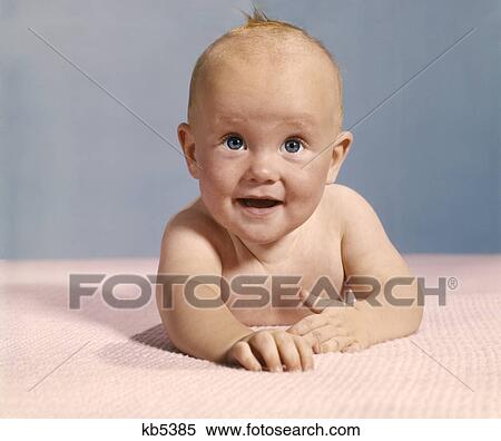 1970s smiling happy bald baby crawling straight ahead on pink blanket View Large Photo Image Stock Photography - 1970s smiling happy bald baby crawling straight ahead on pink blanket. Fotosearch