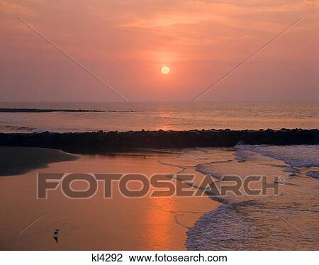 1970s sunrise new jersey shore sun atlantic ocean waves beach breakwater View Large Photo Image Stock Image - 1970s sunrise new jersey shore sun atlantic ocean waves beach breakwater. Fotosearch