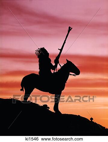 1970s sunset silhouette of native american man wearing headdress on horse at top of a hill View Large Photo Image Stock Photograph - 1970s sunset silhouette of native american man wearing headdress on horse at top of a hill. Fotosearch