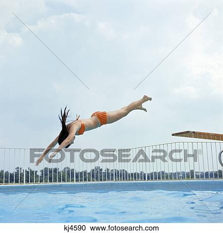 1970s teen girl diving into swimming pool View Large Photo Image Stock Image - 1970s teen girl diving into swimming pool. Fotosearch