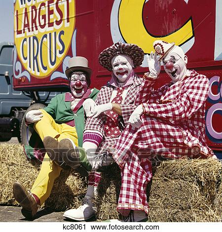 1970s three laughing clowns sitting on hay bales by circus wagon View Large Photo Image Stock Image - 1970s three laughing clowns sitting on hay bales by circus wagon. Fotosearch