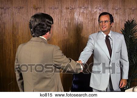 1970s two businessmen shaking hands View Large Photo Image Stock Photography - 1970s two businessmen shaking hands. Fotosearch